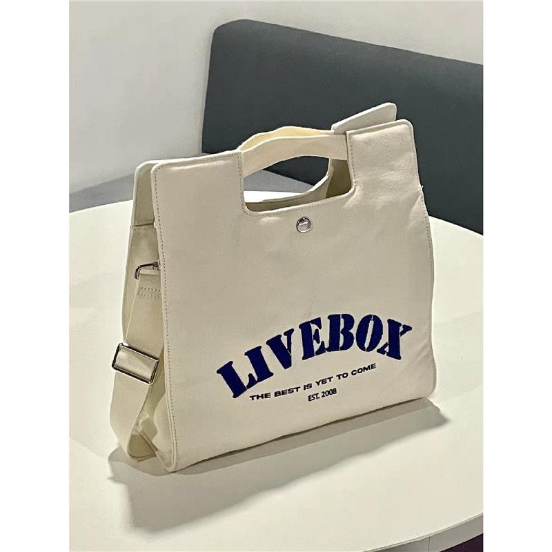 

Japanese niche design alphabet printed canvas tote bag high sense commuting class briefcase large capacity bag білий
