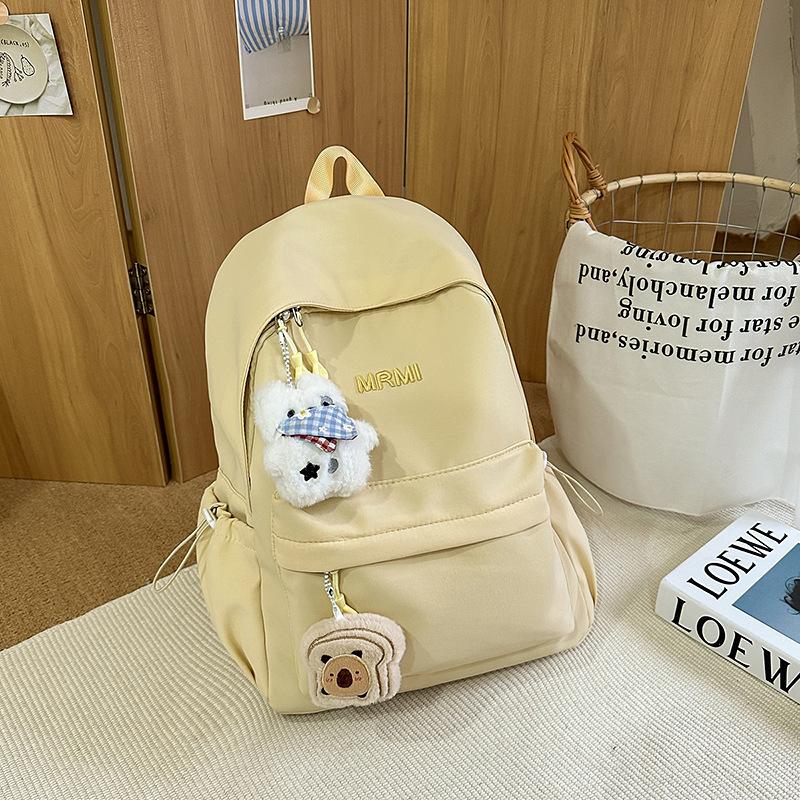 Cream school bag for female junior high school students, high-value niche computer travel backpack, simple and versatile college student backpack