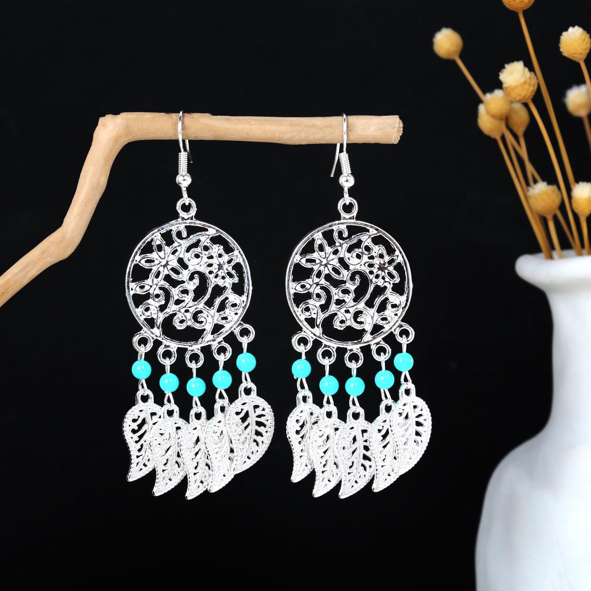 

Барвисті етнічні довгі сережки з пір яними китицями