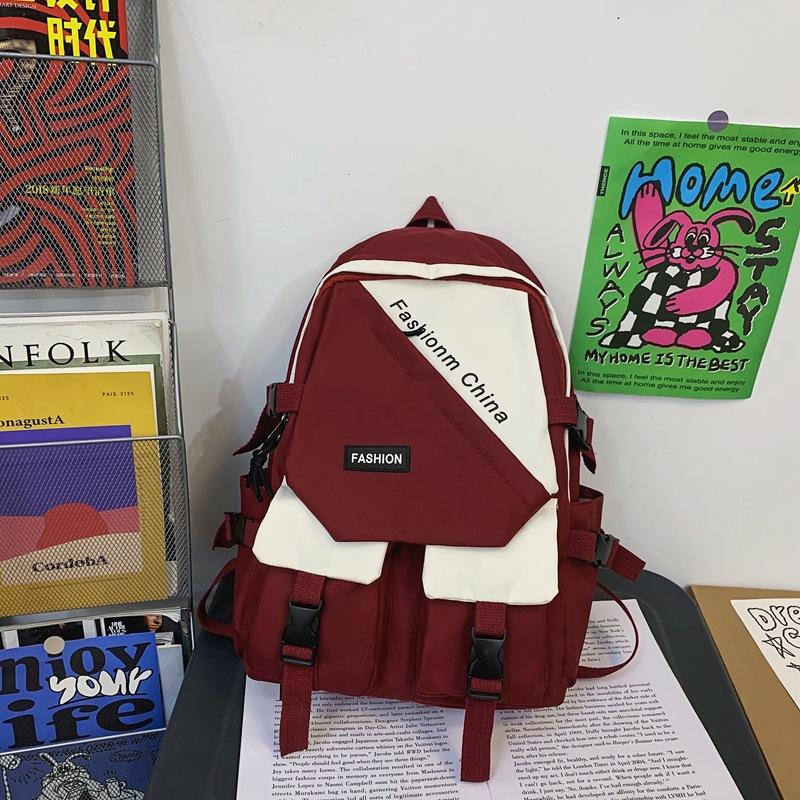 

Korean version of simple backpack tide student casual versatile large capacity lightweight splicing letter lightweight travel backpack красный