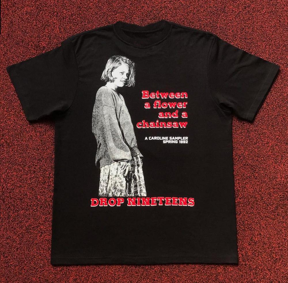 Drop Nineteens Between a flower and a chainsaw T-Shirt Unisex All Size Unisex T-Shirt XL