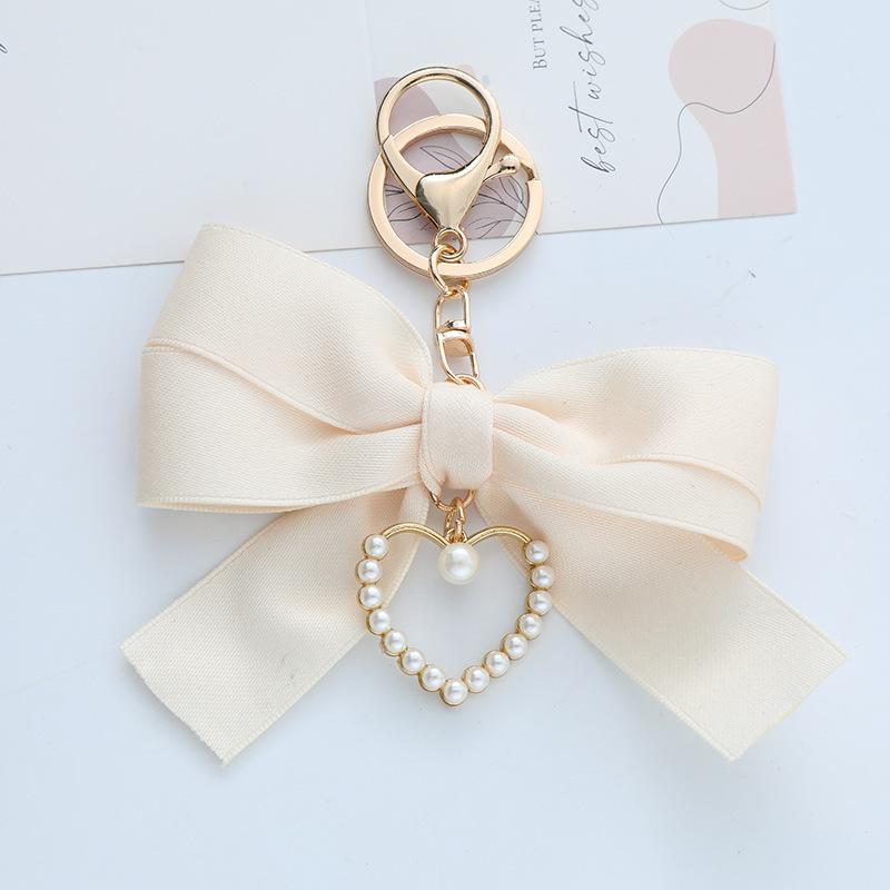 Elegant Pearl Strand Bow Keychain with Heart Charm, Octagonal Shape, Floating Fun-Themed Accessory, with Split Ring Closure for Handbags and Car Keys