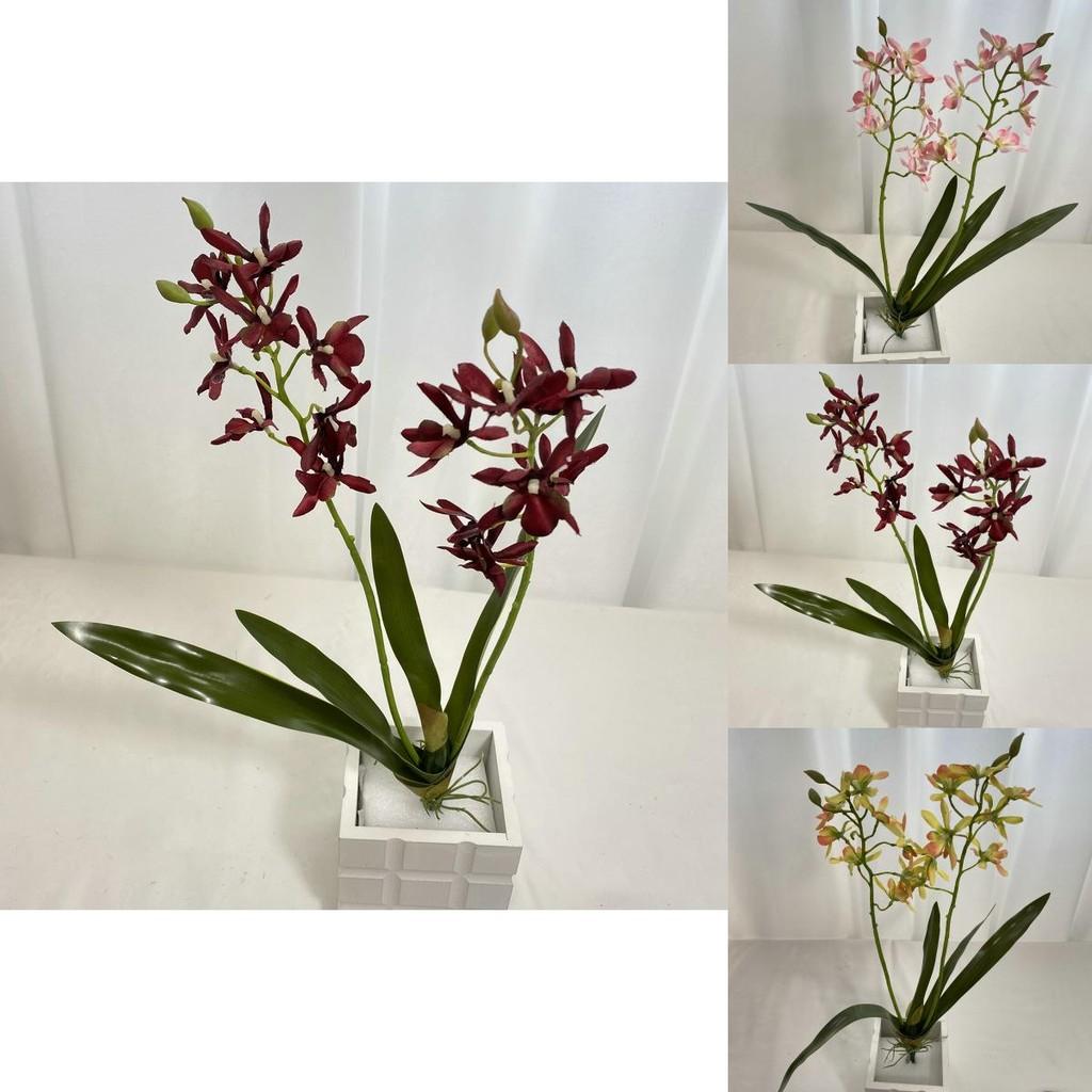 Realistische Seiden-Dendrobium-Orchidee mit Blättern für Blumengesteck auf dem Esstisch