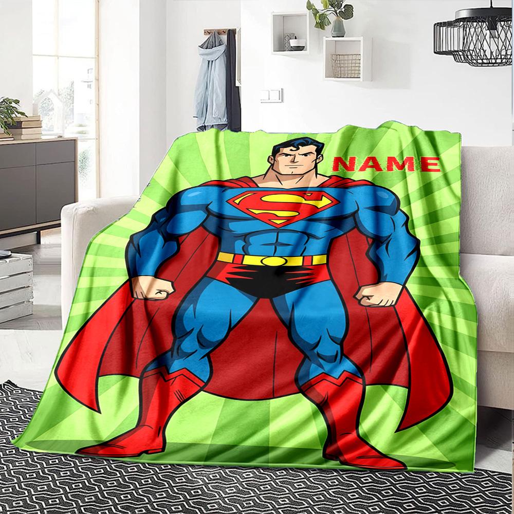 Superman With Red Cape And Blue Suit Standing Confidently On A Green Background With Above Cozy Customizable Blanket Personalized Text Ultrasoft For