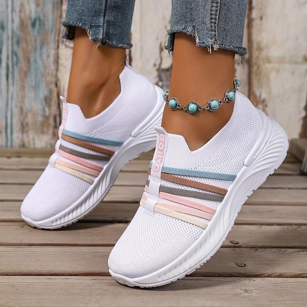 The Lady Wears Slip-On Casual Sports Shoes, Featuring a Breathable Mesh Design with Pastel Stripes, Suitable for Tennis And Comfortable