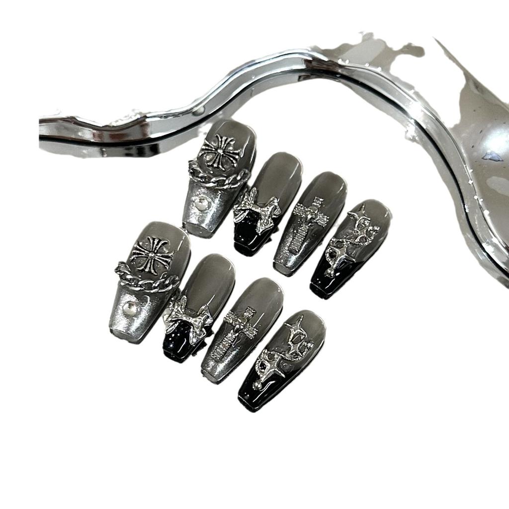 Skin-brightening grey press-on nails featuring detachable black Chrome Hearts-style crosses; entirely handmade.