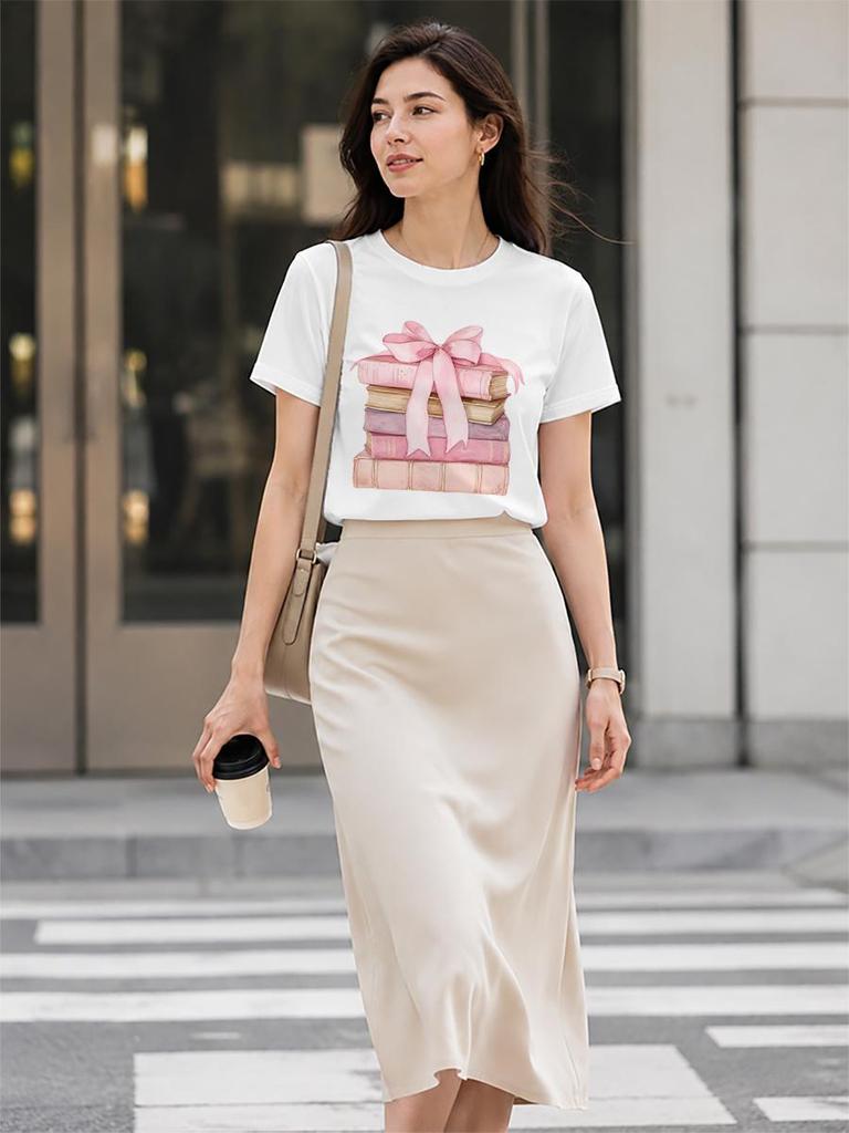 A stylish and versatile white T-shirt with pink book and bow-themed details, perfect for a sophisticated summer look.