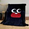 Large cartoon eyes and a red mouth with one tooth on a black background. for all seasons blanket lunch break throw gift
