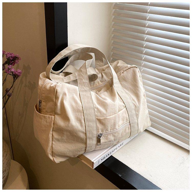 

Легкая сумка-тоут большой вместимости, дорожная сумка из нейлона в форме макарон, женская спортивная сумка через плечо 2024 года, тот же стиль Nanfeng. details page белый