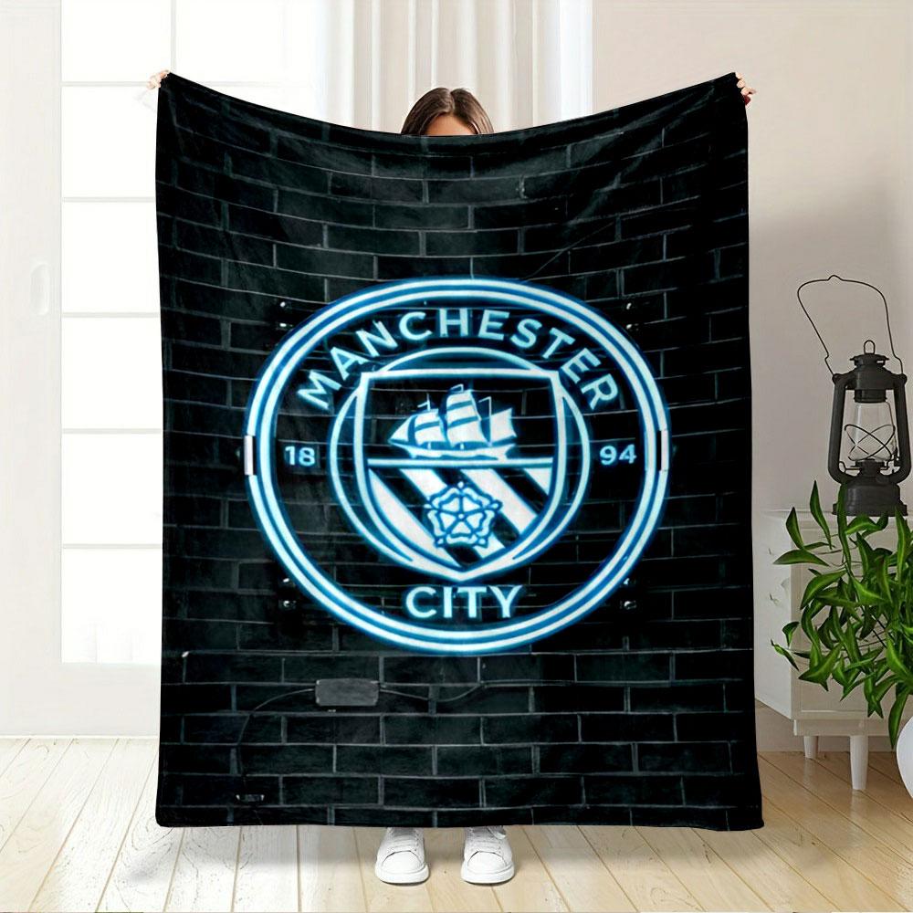 A glowing neon emblem with a ship, rose, and "Manchester City" text. for all seasons blanket lunch break throw gift