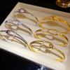 18K Gold-Plated Zircon Knot Clasp Bracelet: Elegant Shimmering Hand Jewelry for Women