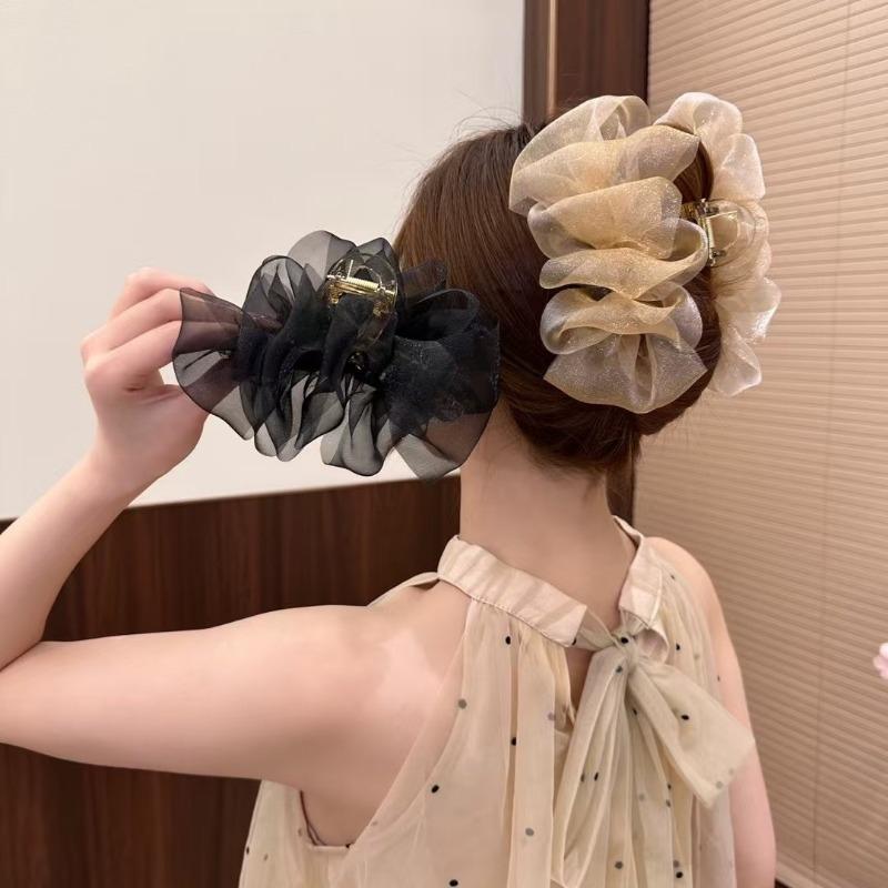 The Mesh Grabber Is Elegant and Feminine with A Lot of Hair On The Back of The Head. It Is A Shark Clip Hair Accessory