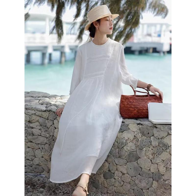 A Woman In A Double Layered Mid Length White Dress