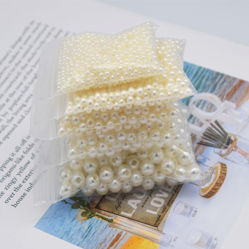 Koraliki z imitacji pereł w kolorze złamanej bieli z podwójnym otworem 4-20 mm do samodzielnego wykonania, opakowanie 50 g