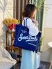 Large Capacity Canvas Tote Bag with Denim Fabric and Tassel Design for Commuting