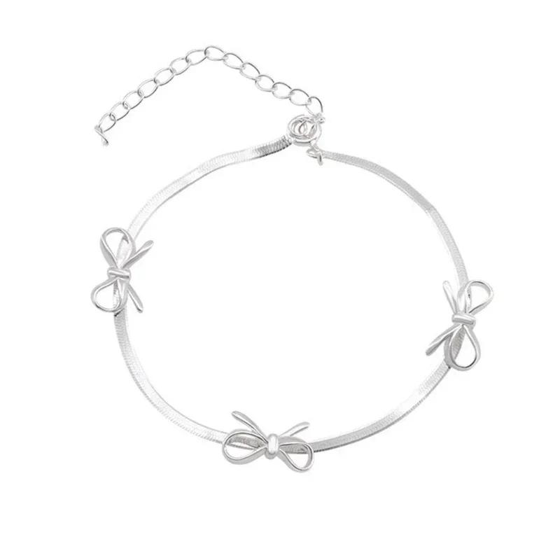 

Модное колье/браслет в виде цепочки «змеиная кость» с элегантной подвеской-бантиком — стильный аксессуар для различных случаев