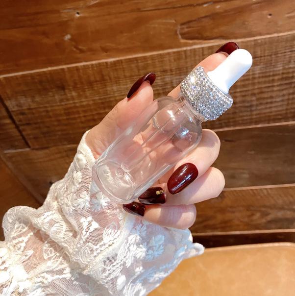 Diamond-Inlaid Frosted Glass Essential Oil Bottle with Rubber Dropper for Serums and Liquid Cosmetics.