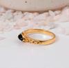 Black Onyx Marquise Gold Ring: Elegant vintage-style jewelry with a dark navette gemstone and ornate filigree band.