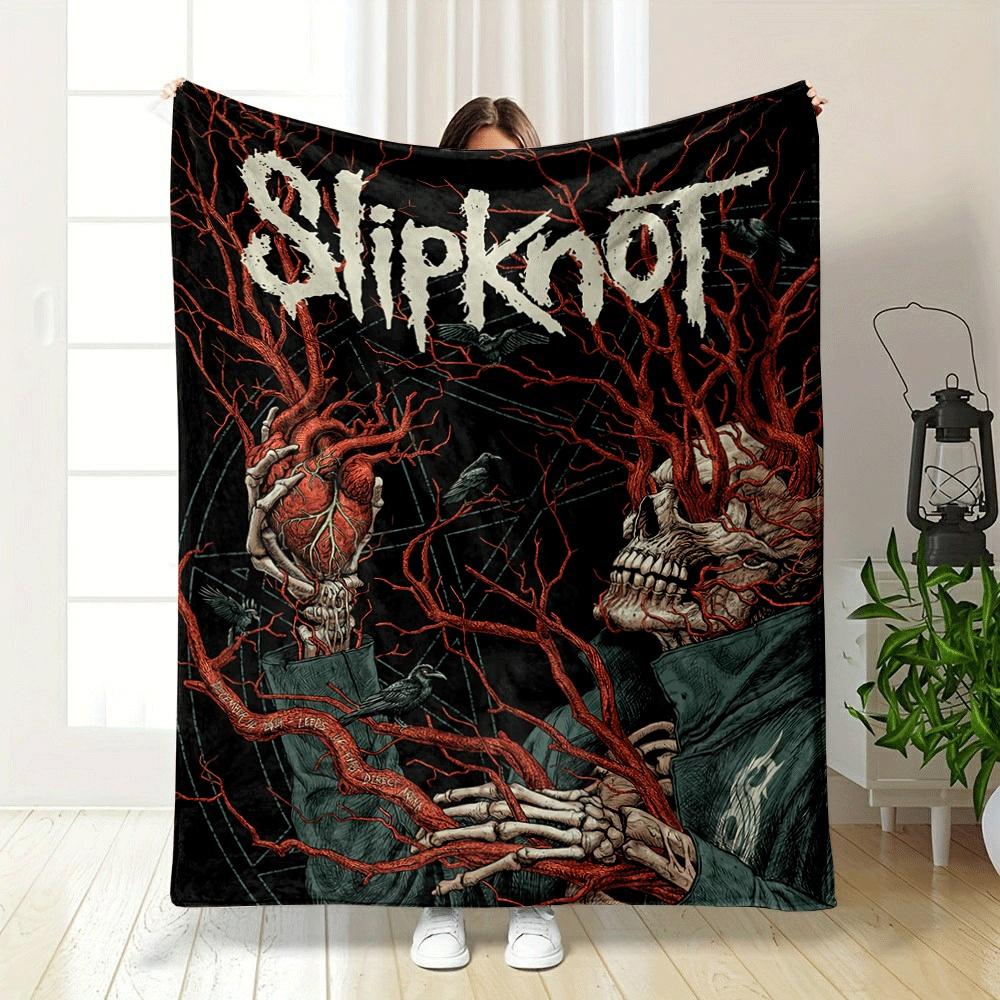 A skeletal figure intertwined with red veins, holding a human heart. for all seasons blanket lunch break throw gift