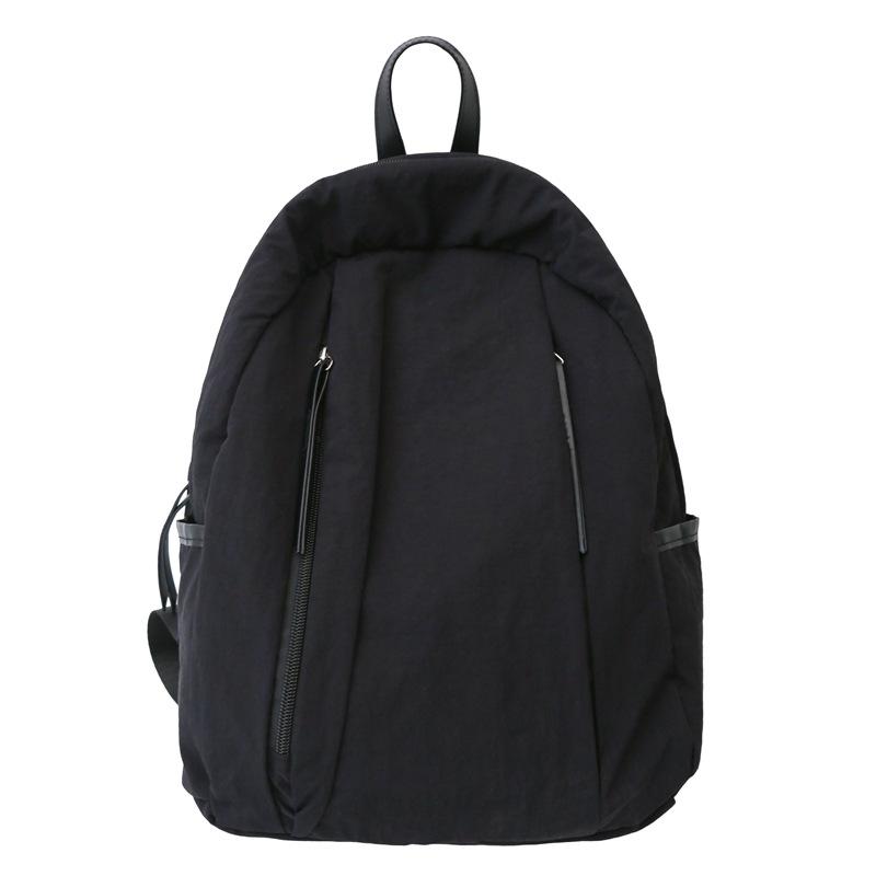 

Korean relaxation lazy style schoolbag female niche high value lightweight college student simple solid color casual backpack чорний
