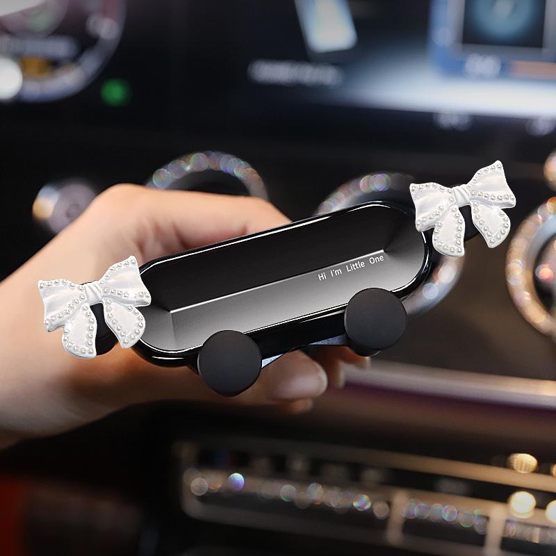 

Cute Bowknot Universal Car Phone Holder Cartoon Diamond GPS Stand Gravity Bracket Auto Air Vent Clip Mount Mobile Phone Holder перлина білого кольору