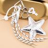 MIU Series Leopard Print PU Leather Pentagram Bag Charm with Bow and Handmade Woven Keyring