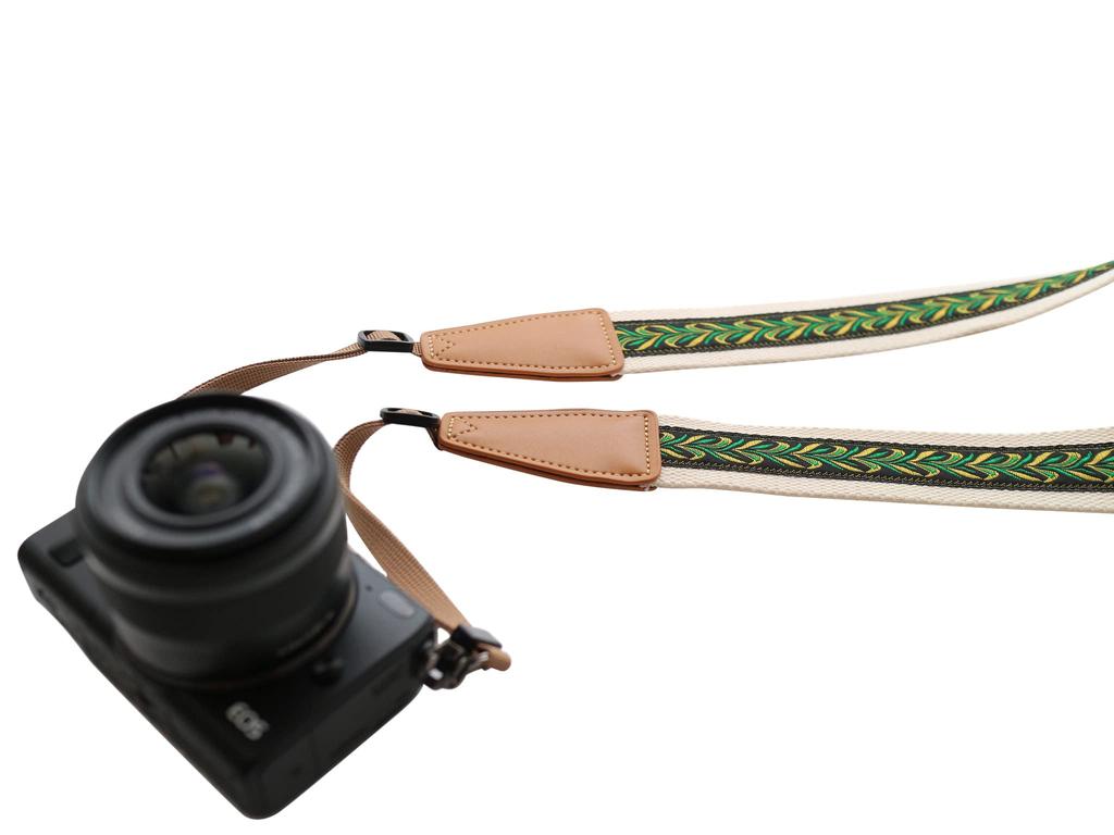 A unique camera strap with an original featuring a Compatible with mirrorless and SLR cameras from and [UNIKSTRAP] design, vintage-style "peacock