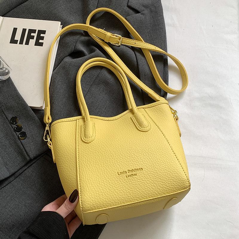 Stylish and Simple Style Lychee Pattern Texture Portable Bucket Bag Korean Version Casual Commuting Versatile Solid Color Messenger Women's Bag