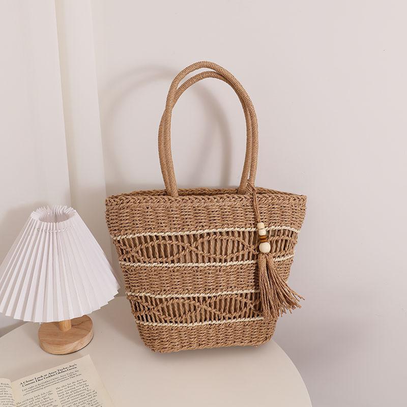 IELGY fashion hollow shoulder straw bag, fringed hand-woven holiday wind beach women's bag