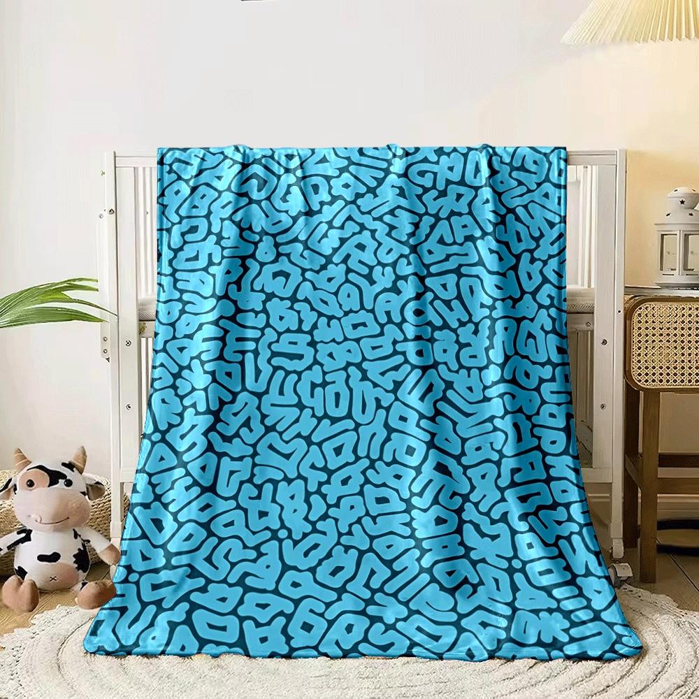 Organic, irregular blue shapes resembling abstract lettering on dark teal. for all seasons blanket lunch break throw gift 80cm x 120cm