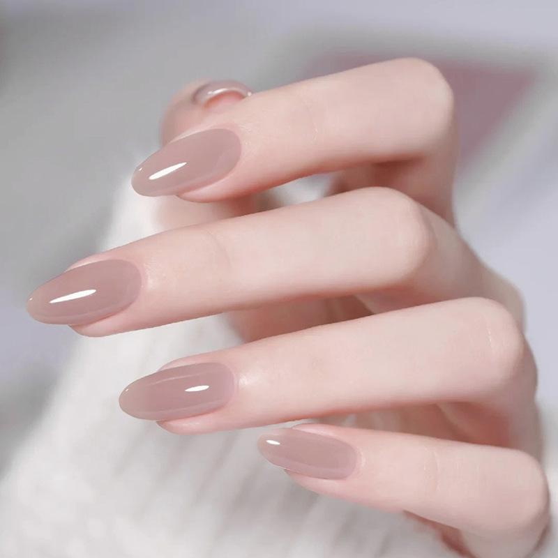 24Pcs Solid Nude Color Fake Nails with Pink Design Short Almond Press on False Nails Wearable Oval Finished Full Cover Nail Tips