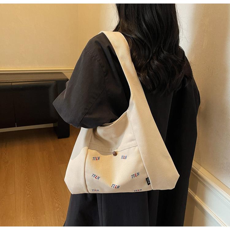 Canvas bag Women's shoulder bag Large capacity commuter tote bag Versatile student armpit bag