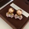 French champagne striped bow stud earrings women's new two bead earrings temperament accessories light luxury high sense