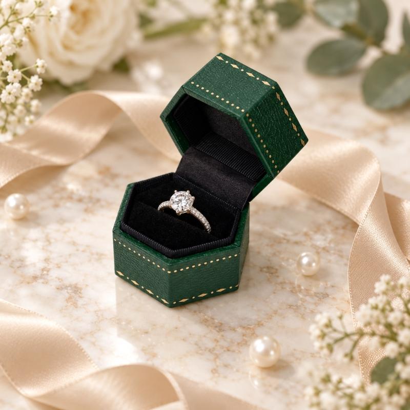 Hexagonal Ring Presentation Box with Black Interior, Gold-Tone Border Pattern, and Attached Lid for Retail Display