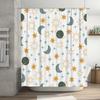 Space-themed shower curtain with celestial pattern featuring suns, moons, stars, and planets in green, blue, and orange colors