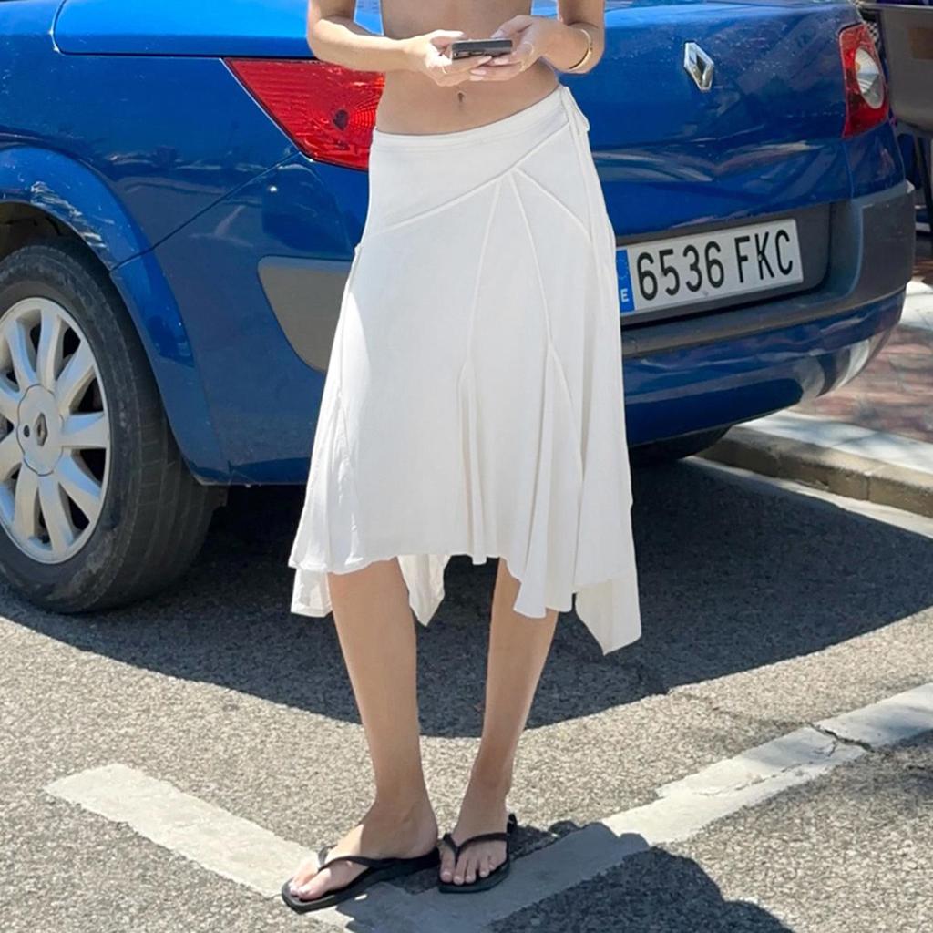 Elegant French White Irregular Half Skirt with Flowing Drape, Side Tie, and Low Waist Design