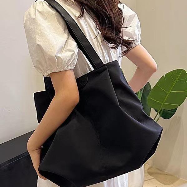 Women's new one-shoulder handbag, separated tote bag, large-capacity hand-carried canvas bag.