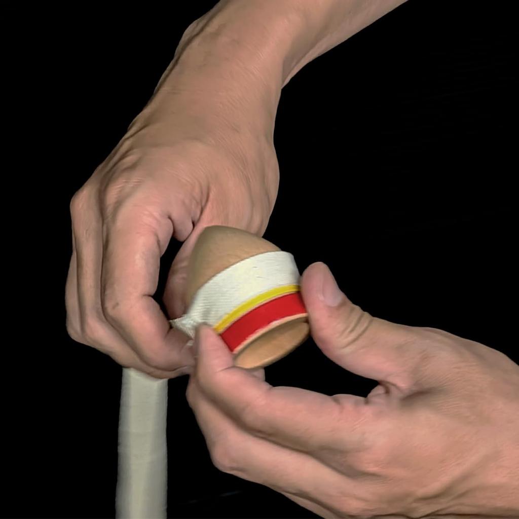 Spin Gear - A Traditional Spinning Top Spun by Hitting It with a String. It Spins Well On Its Iron Axis (colored).