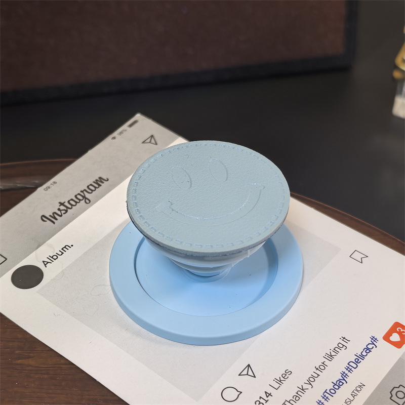 

Dopamine Solid Color Leather Texture Smiley Face MagSafe Airbag Phone Holder