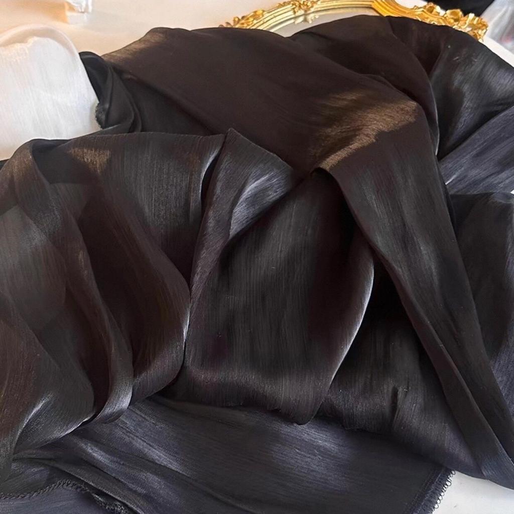 Soft shiny creased organza fabric with a smooth texture suitable for wedding dresses formal gowns and designer clothing fabrics