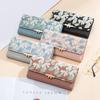 Cartera larga para mujer con estampado de flores y tres pliegues