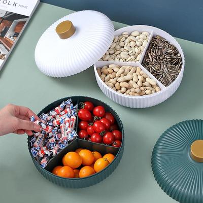 Boîte de rangement ronde légère et luxueuse pour fruits secs avec couvercle pour table basse de salon, boîte à bonbons simple, support à assiettes de fruits de nouveau style.