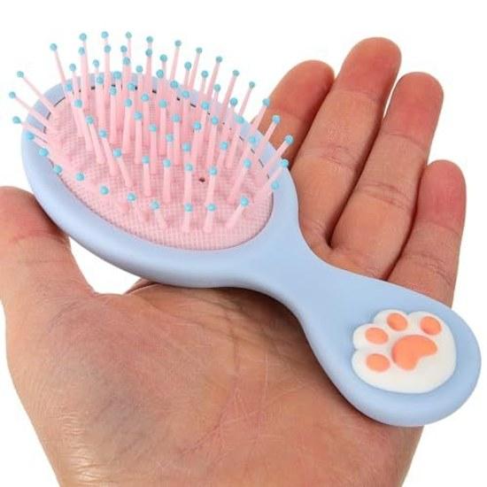 small hairbrush girls shape cats paw made from blue ABS material. It features excellent detangling capabilities durability making ideal caring dry