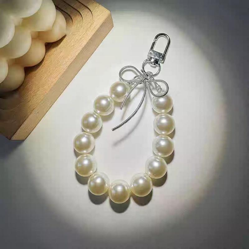 

Advanced feeling electroplated silver pearl mobile phone strap, sweet bow headphone case, bag, car key pendant білий