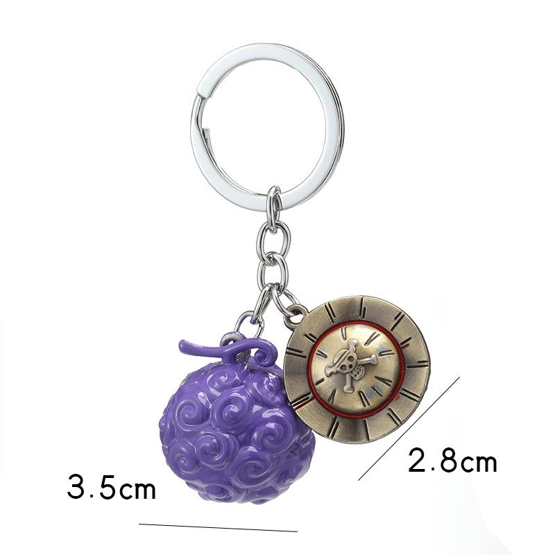 

Set of 2 One Piece Devil Fruit Keychains: Law s Ope Ope Fruit & Ace s Mera Mera Fruit фіолетовий