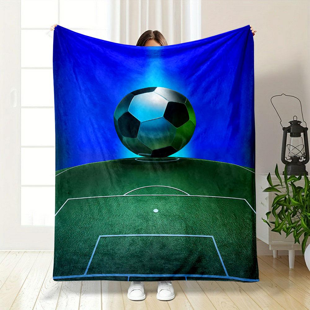 A soccer ball hovers above a green field with glowing blue background. for all seasons blanket lunch break throw gift