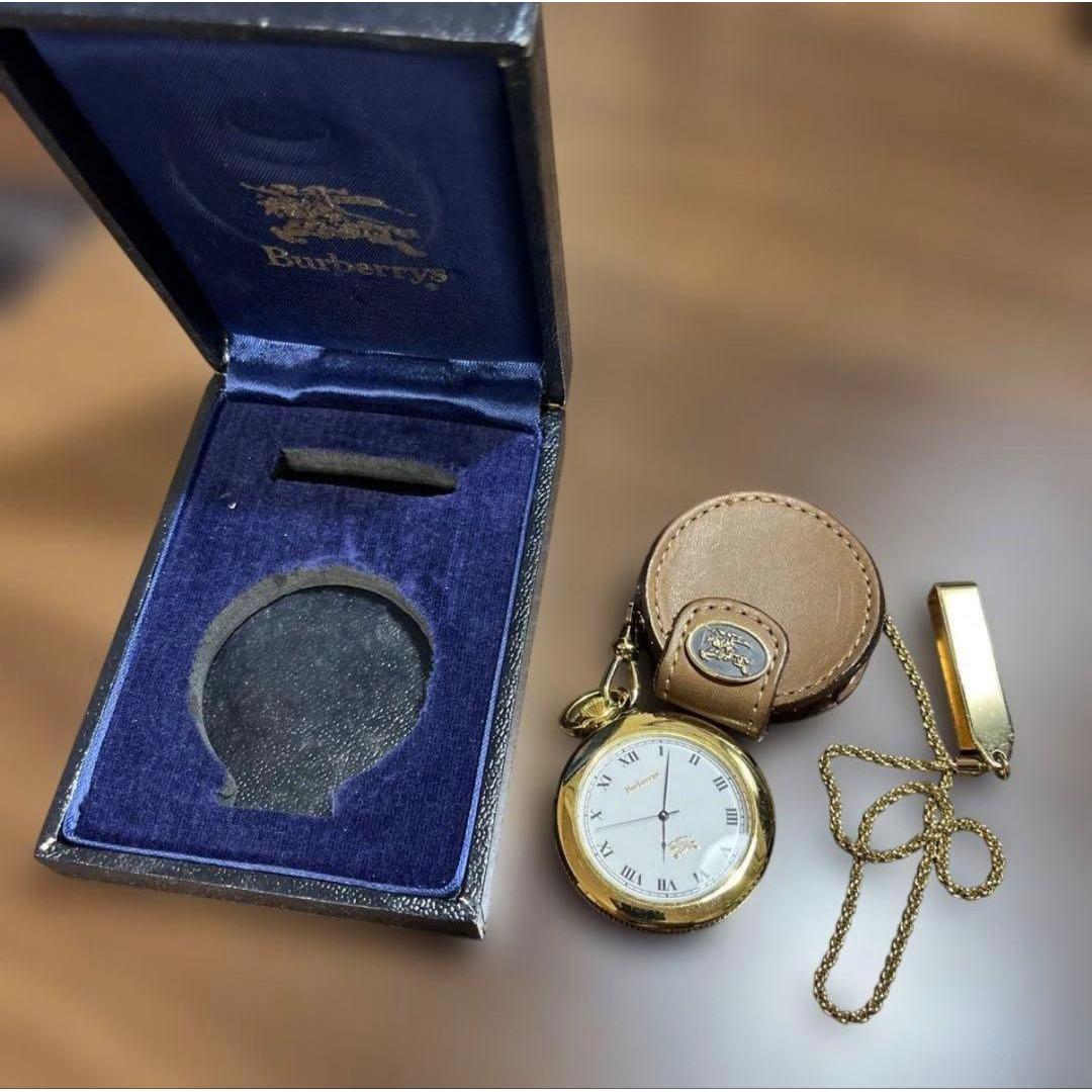 Used Burberry pocket watch gold color with leather case and chain