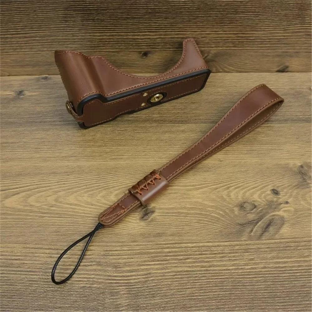 Półpokrowiec na aparat z PU skóry dla Canon EOS R50 R100, dolna pokrywa z paskiem na rękę, otwór na baterię