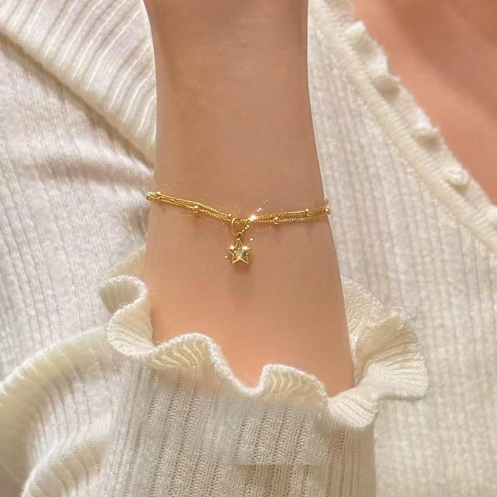 Gold Double-Layer Star Pendant Bracelet for Women - Small Wrist Design, Unique & Elegant.