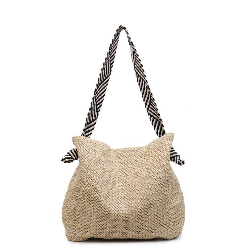 Hollow Straw Woven Tote: Fashionable, Large Capacity Shoulder & Handheld Bag for Seaside Vacation or Commute.